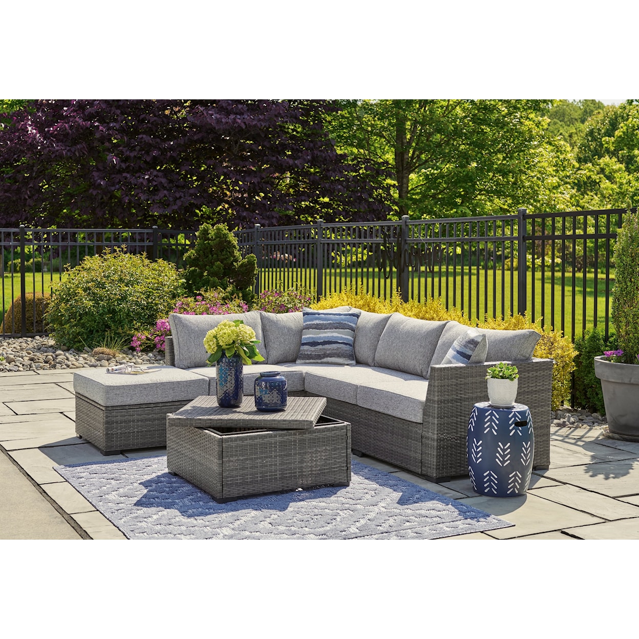 Ashley Furniture Signature Design Petal Road Outdoor Sectional Set with Ottoman & Table