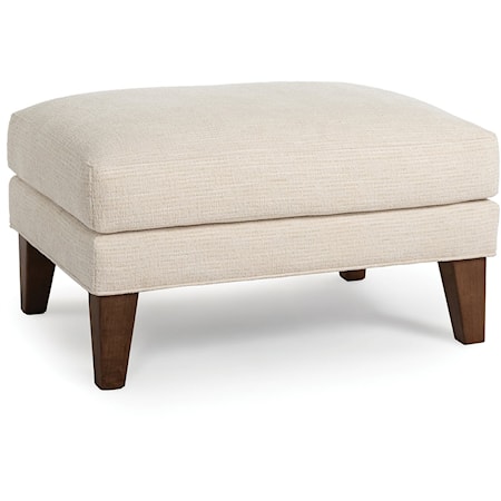 Transitional Upholstered Ottoman with Exposed Wood Legs