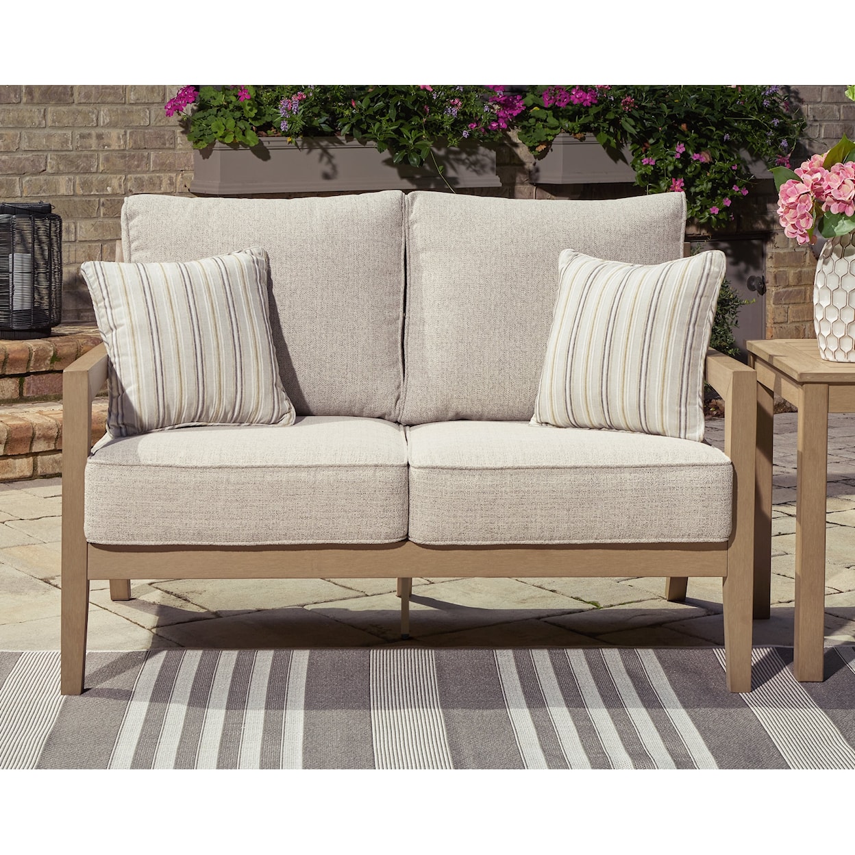 Ashley Signature Design Hallow Creek Outdoor Loveseat with Cushion