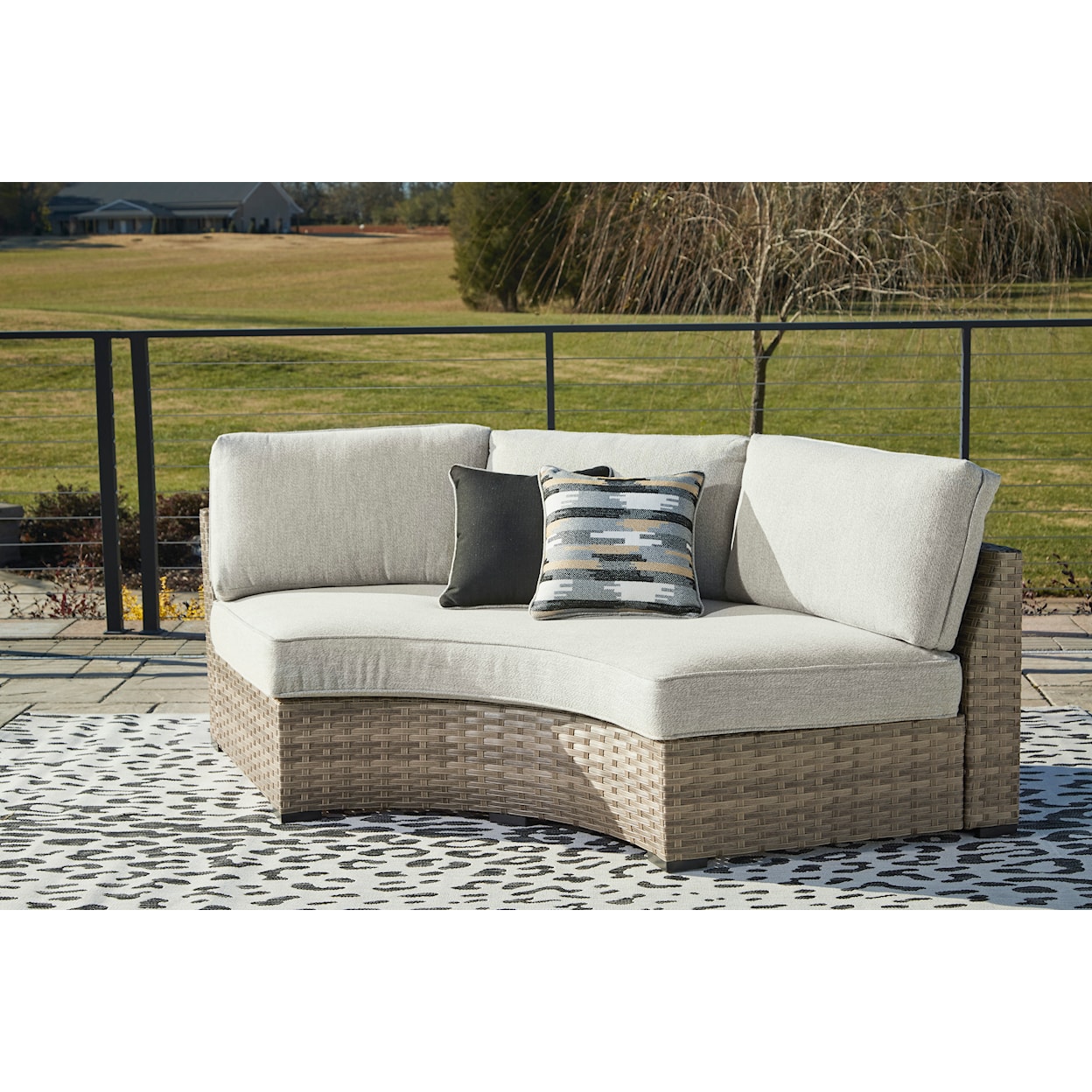 Ashley Furniture Signature Design Calworth Outdoor Curved Loveseat with Cushion