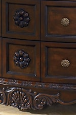 Embossed Wood Flowers and Wood Aprons with Flower like Drawer Handles on the Dresser