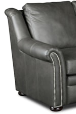 A Bold Pattern of Nailheads Adds a Modern Edge to a Traditional Rolled Style of Sofa