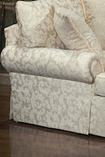 A loose pillow back adds modern comfort while rolled arms and a base skirt offer traditional style