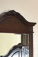 The Mirror's Crown Echoes the Decorative Headboard