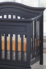 Clean slatted crib with a curved, serpentine top