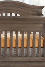 Clean slatted crib with a curved, serpentine top