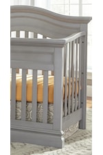 Clean slatted crib with a curved, serpentine top
