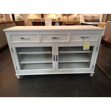 RIVERSIDE FURNITURE- OSBORNE SIDEBOARD- Winter White finish. 
   Constructed of hardwood solid and Ash veneer.

All drawers have dovetail joinery, ball-bearing extension guides, and felt-lined bottoms.

Each wood framed glass door encloses two adjustable and reversible wine bottle storage shelves that can be flipped and used as a standard shelf.

58.00"W X 19.00"D X 36.00"H

