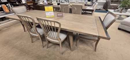 This Kincaid solid wood table will enhance any dining space. Wire-brush finish, metal and upholstered accents, this modern rustic table is full of charm and functionality.