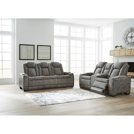 Next-Gen DuraPella Slate Power Reclining Sofa and Loveseat (FLOOR MODEL ONLY)

This sleek, ultra-modern power reclining sofa has it all. With designer looks and head-to-toe comfort, it has the upscale look of leather at a scaled-down faux leather price. Its gray two-tone upholstery is more durable and water-repellent than regular leather, an added bonus for families with children or pets. Features including wireless and USB charging, an adjustable headrest and a "zero-gravity" ottoman for improved circulation make this the next generation of power recliners.

Sofa:  86"W  39.5"D  43"H
Loveseat:  75"W  39.5"D  43"H