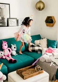 girl playing on green sectional