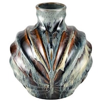 The Kelly Vase has a medium rounded shape with a dynamic ridged texture