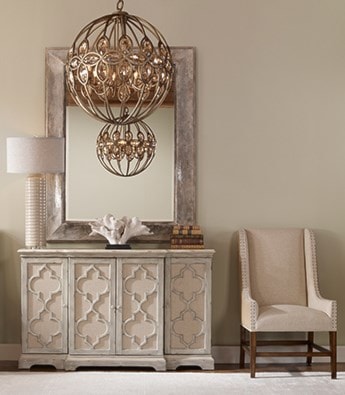 Accent Chest next to a Chair with a bronze chandellier