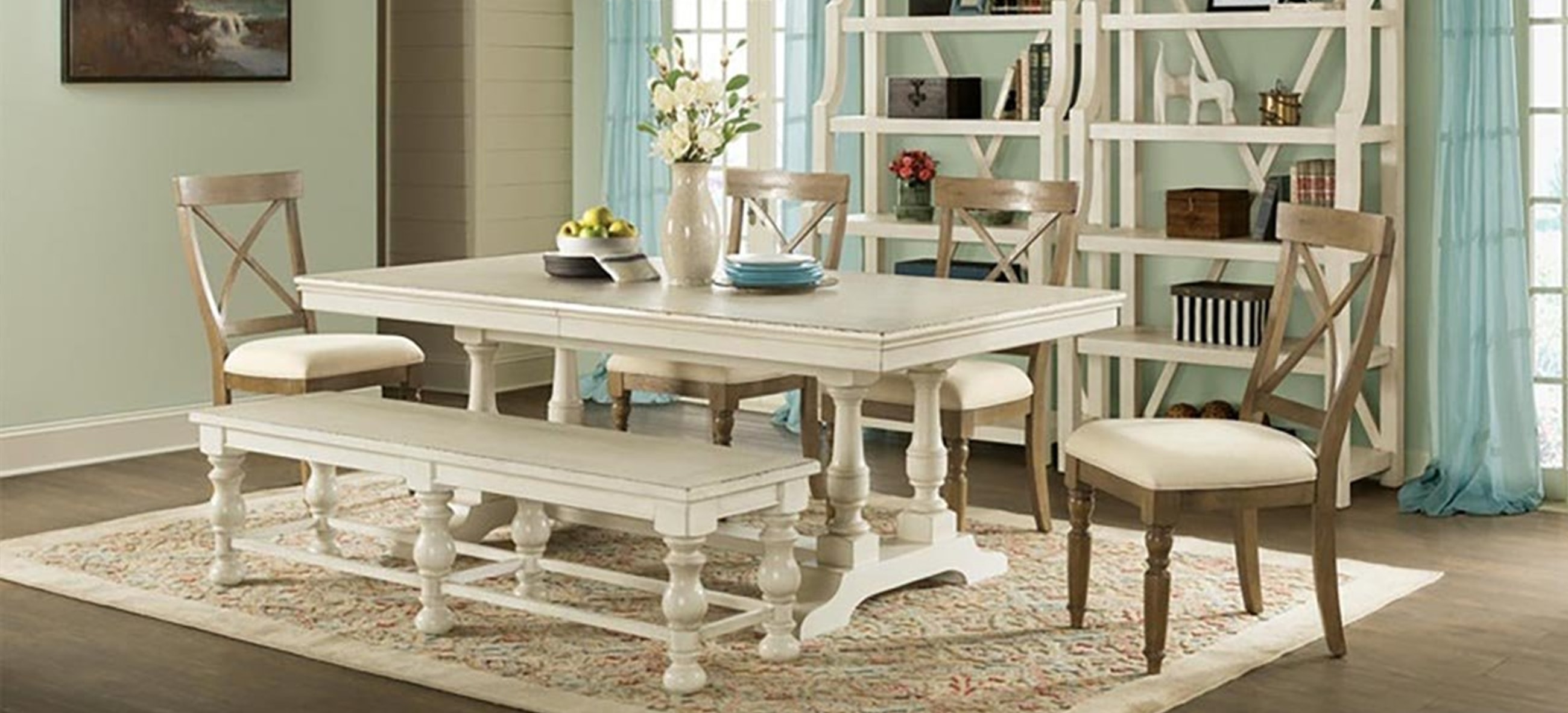 A stylish vase with flowers on a dining room table.