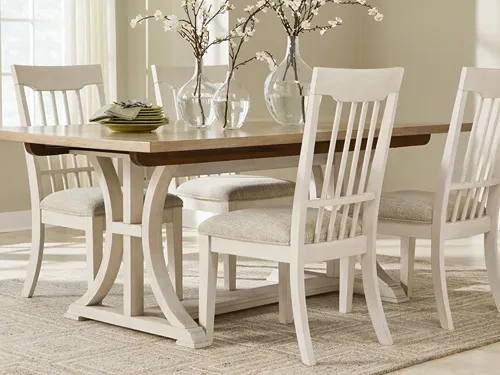 5-piece dining set with four white side chairs with upholstered seats and a two-toned dining table