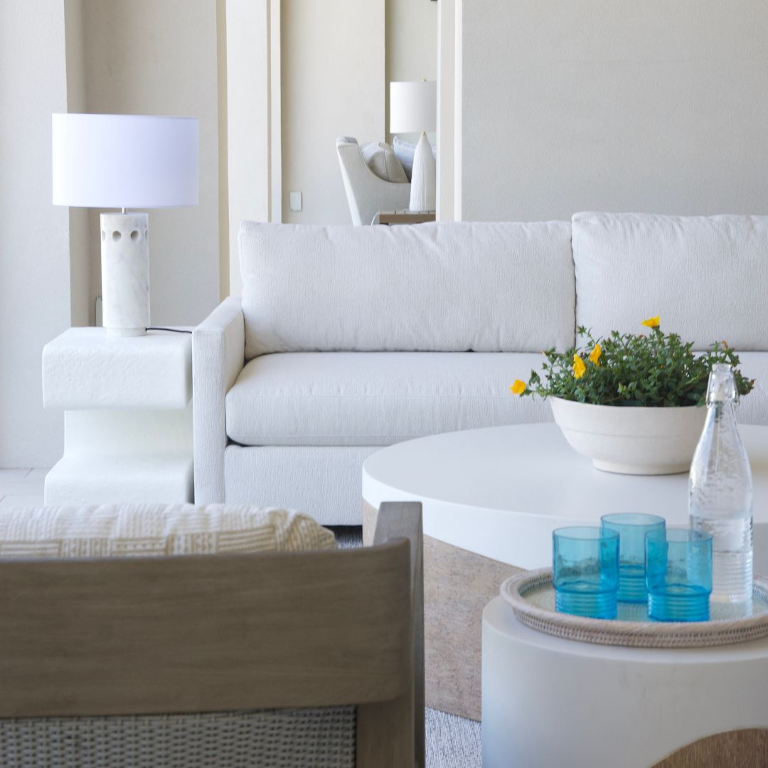 living room image with white sofa, white end table and round white coffee table