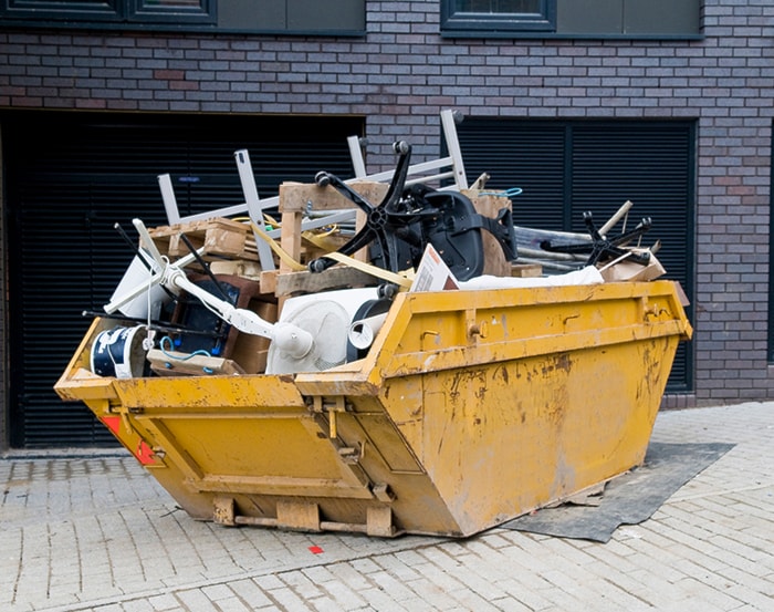 Yellow Dumpster Full of Furniture