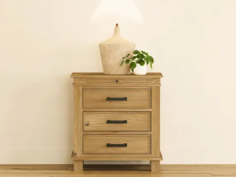 Wooden nightstand with three drawers and decor on top