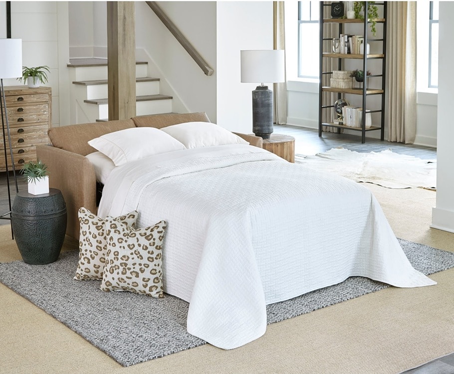 Brown futon that has made turned into a bed