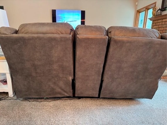 Another back view of a reclining sofa with gaps in between the three seats