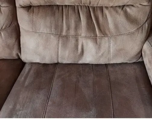 Reclining sofa with worn-down cushions