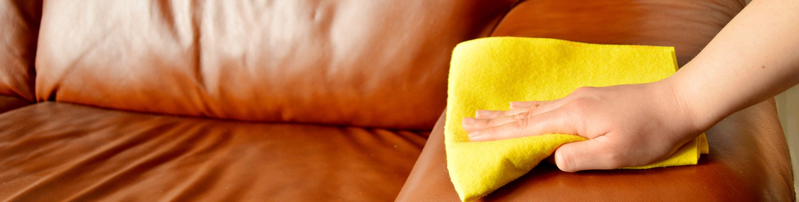 Close up of someone cleaning a sofa