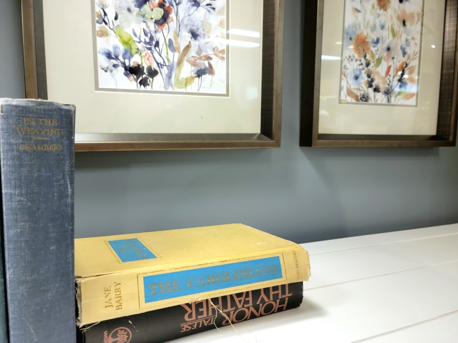 Closeup of books, desk and artwork