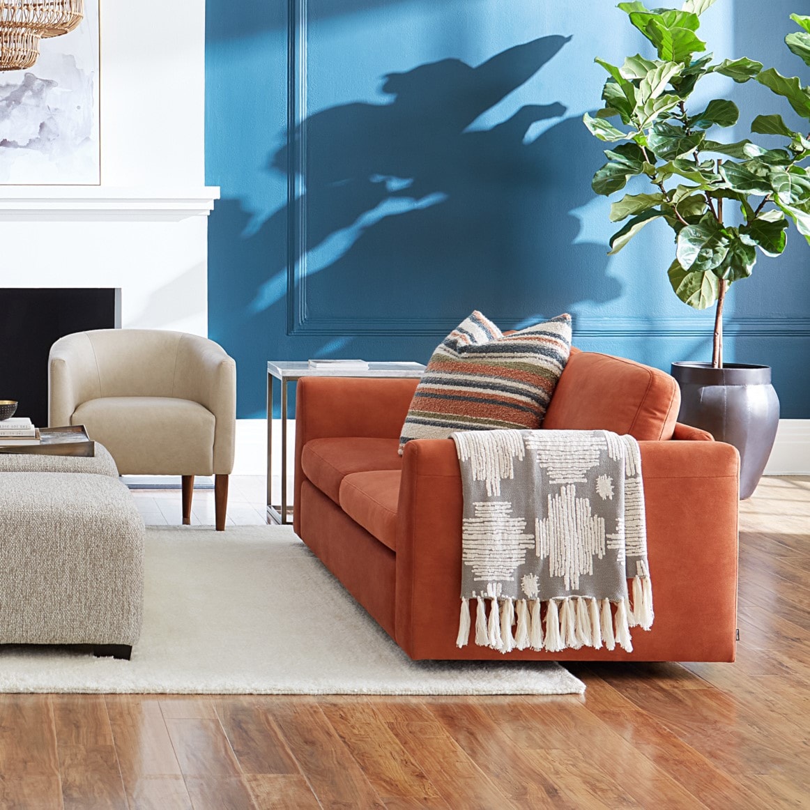 Orange Palliser Sofa with Blue Walls and Striped Toss Cushion