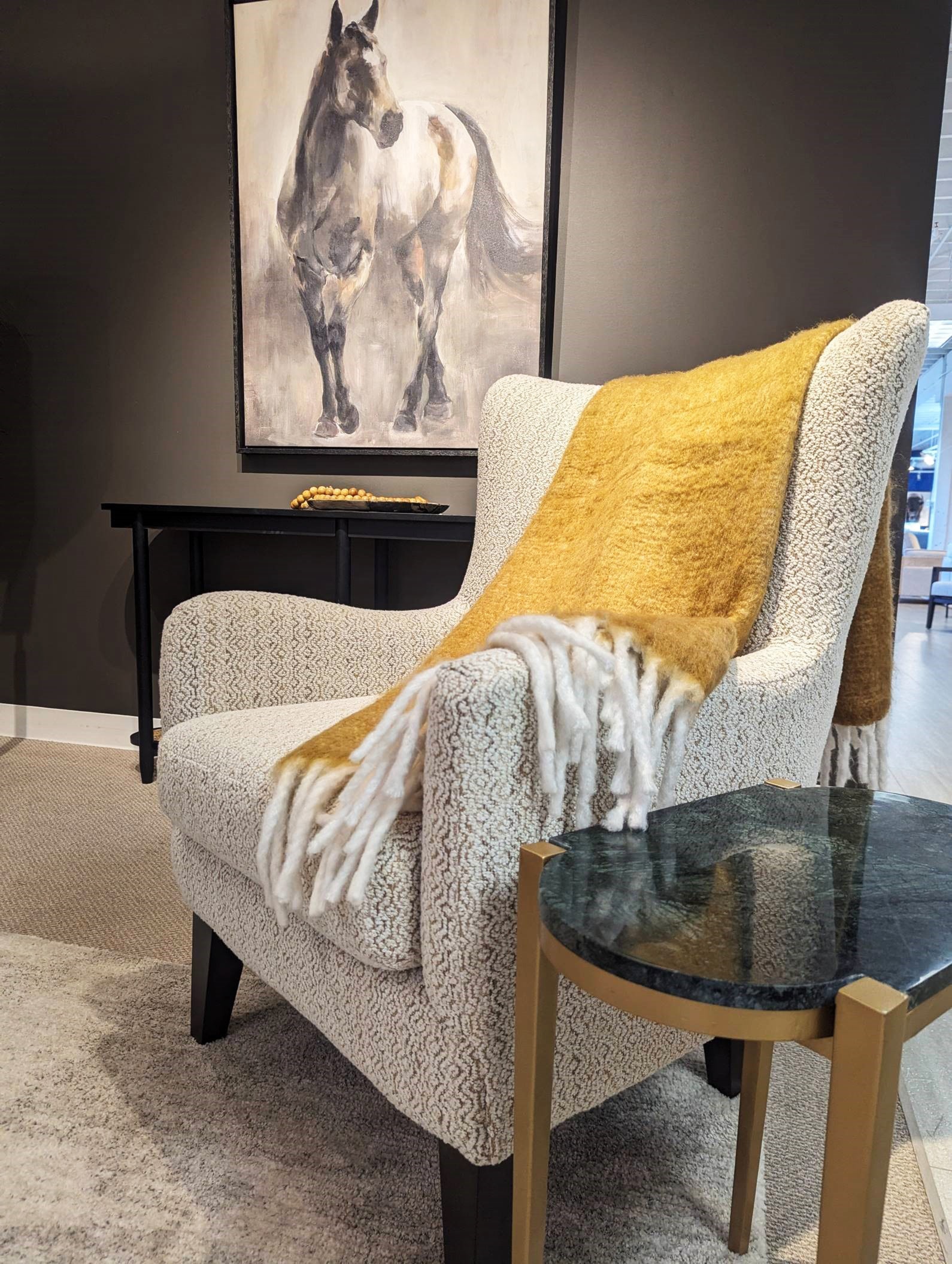 Accent Chair with Yellow Throw Blanket and Wall Art with Horse on it behind