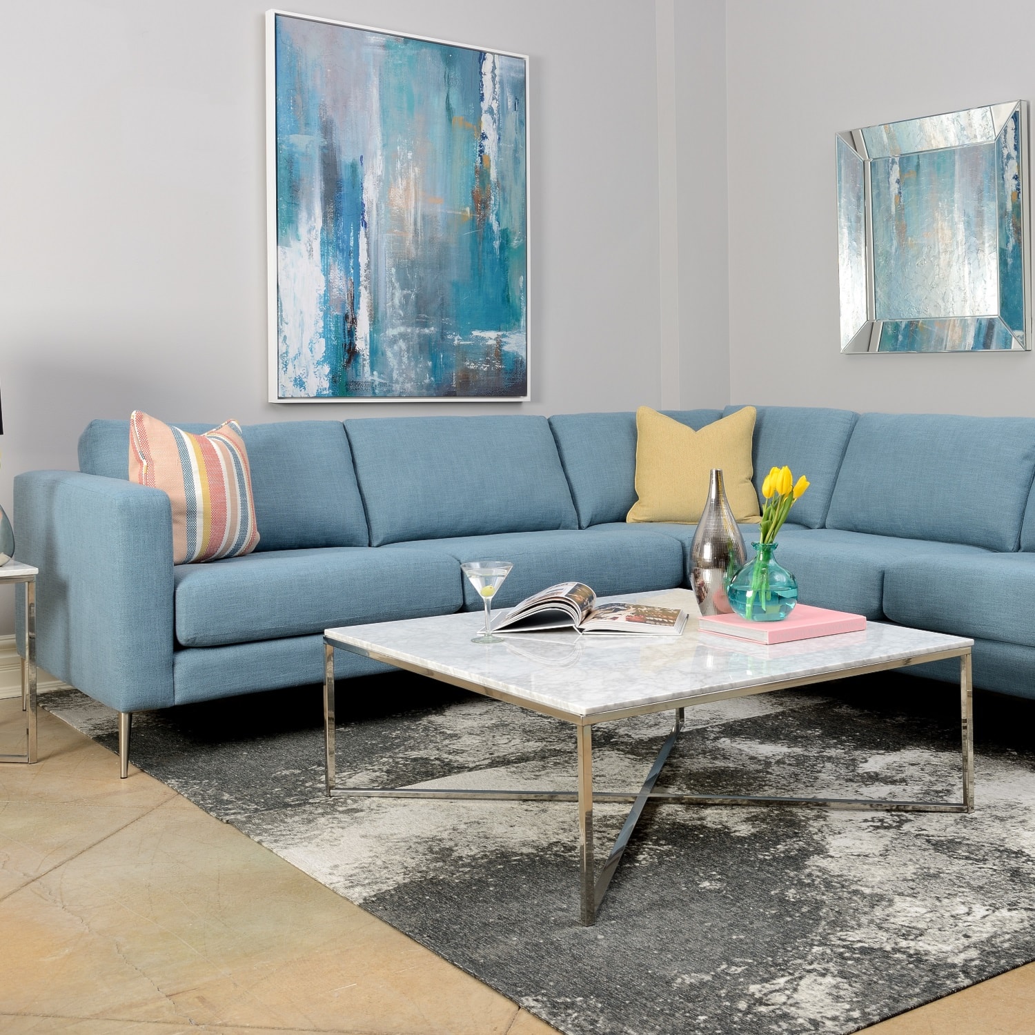 Blue sectional with colourful toss cushions