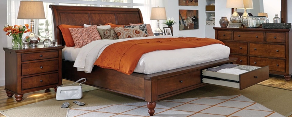 wood bed with orange bedding accents