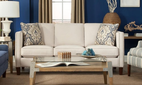 white modern sofa infront of royal blue wall