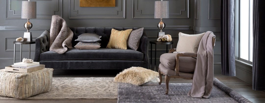 dark grey velvet sofa in a moody room