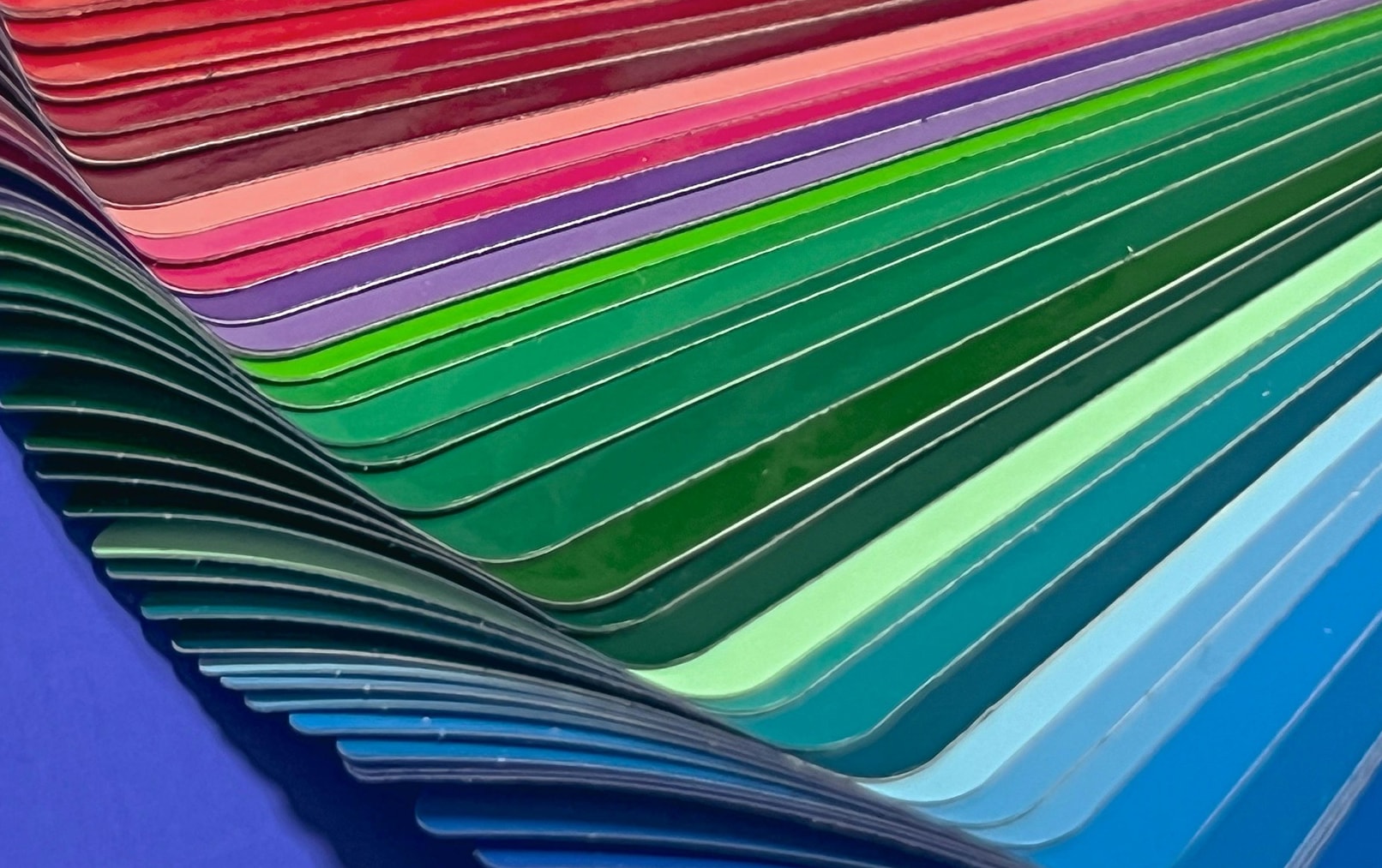 many colorful paint swatches stacked and fanned out