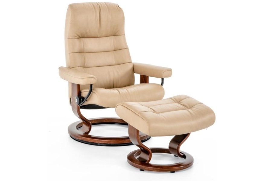 A leather cream colored recliner with a matching ottoman. 