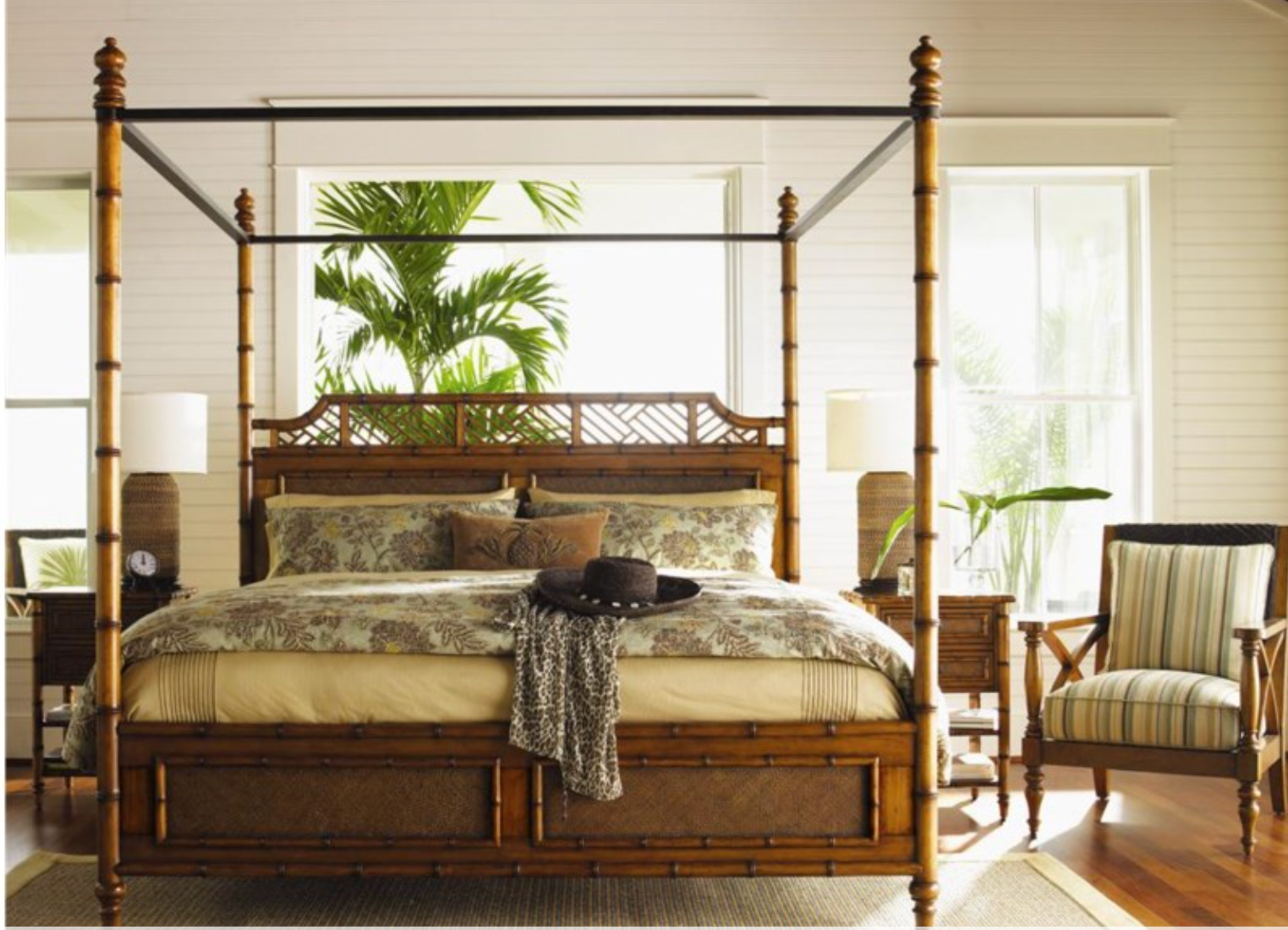 Tropical style bedroom with a canopy bed in the center. 
