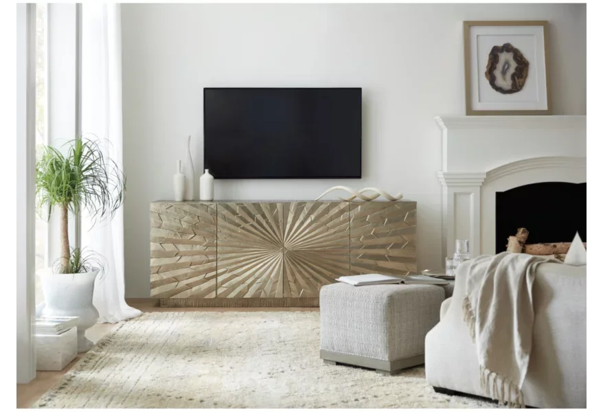 Living room with a gold-colored console featuring a large starburst pattern under the TV. 