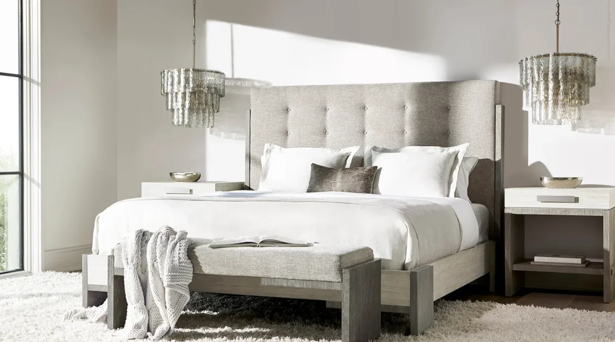 Modern bedroom with soft, upholstered bed. 