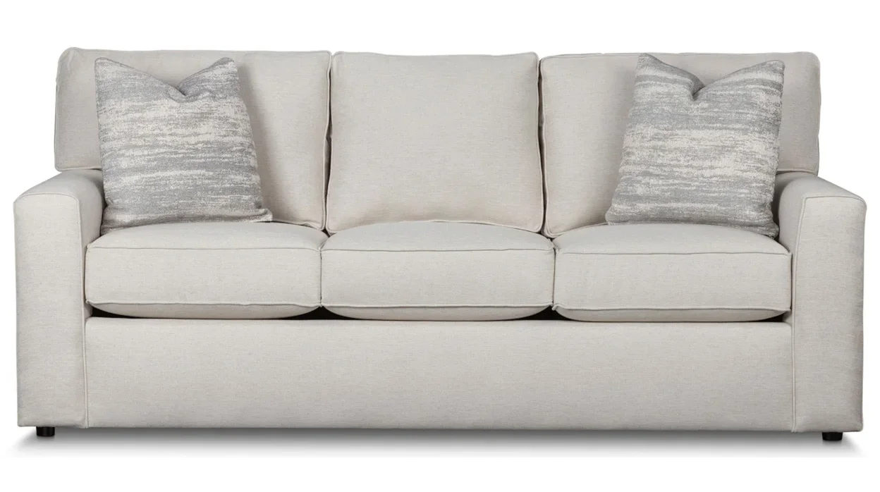 Minimalist upholstered sofa with two throw pillows. 
