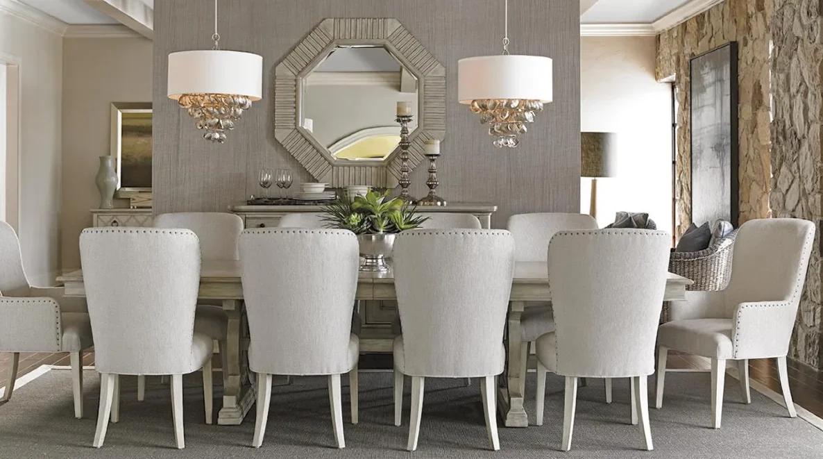 Elegant dining room table surrounded by upholstered dining chairs. 