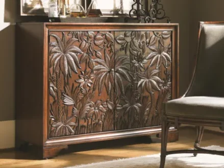 Wooden cabinet with tropical carvings on the doors. 