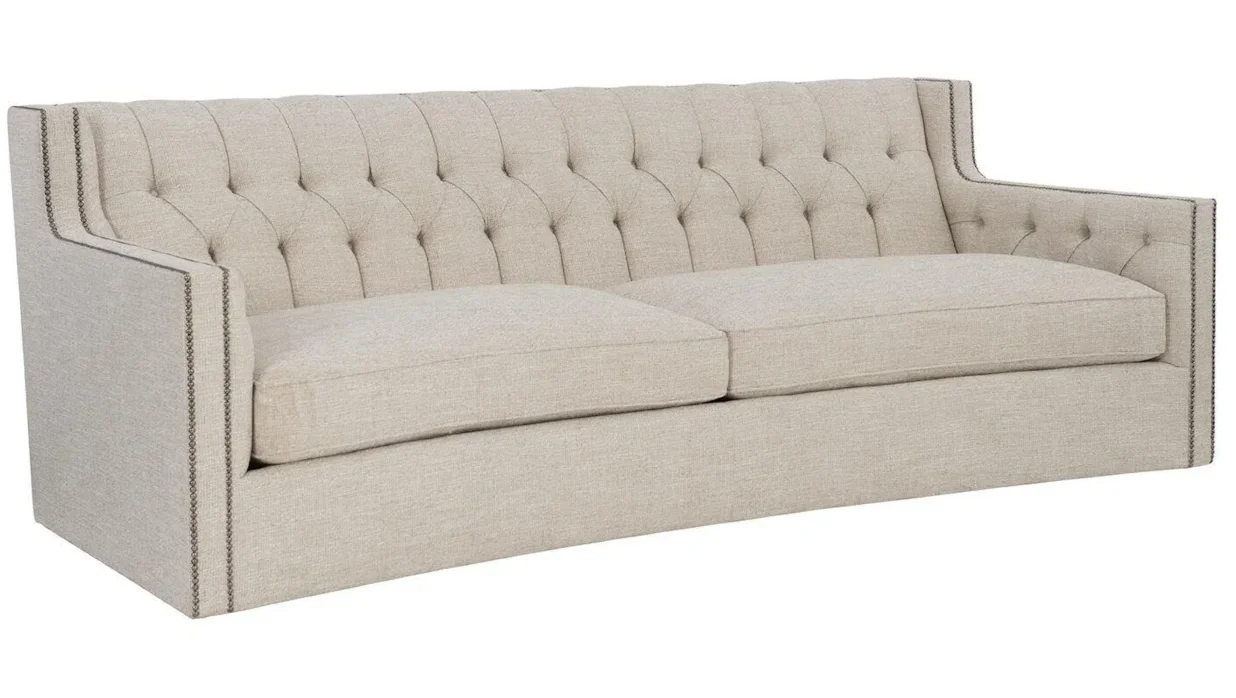 Upholstered curved sofa against a plain white background. 