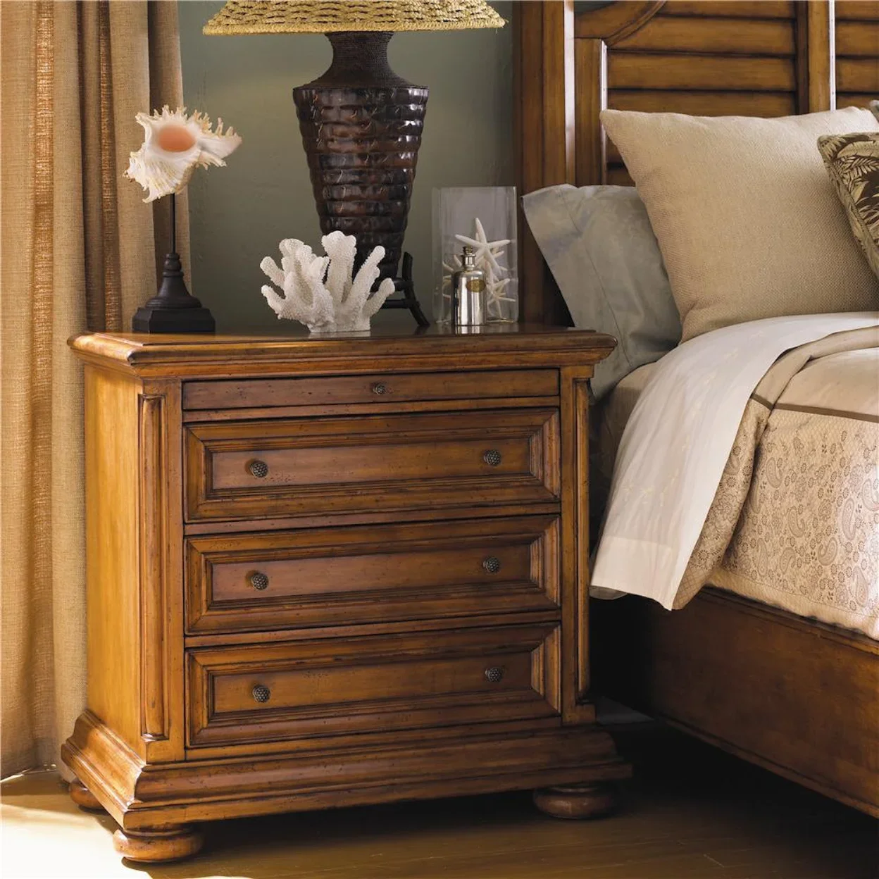 Beautiful wooden night stand beside a bed and window. 