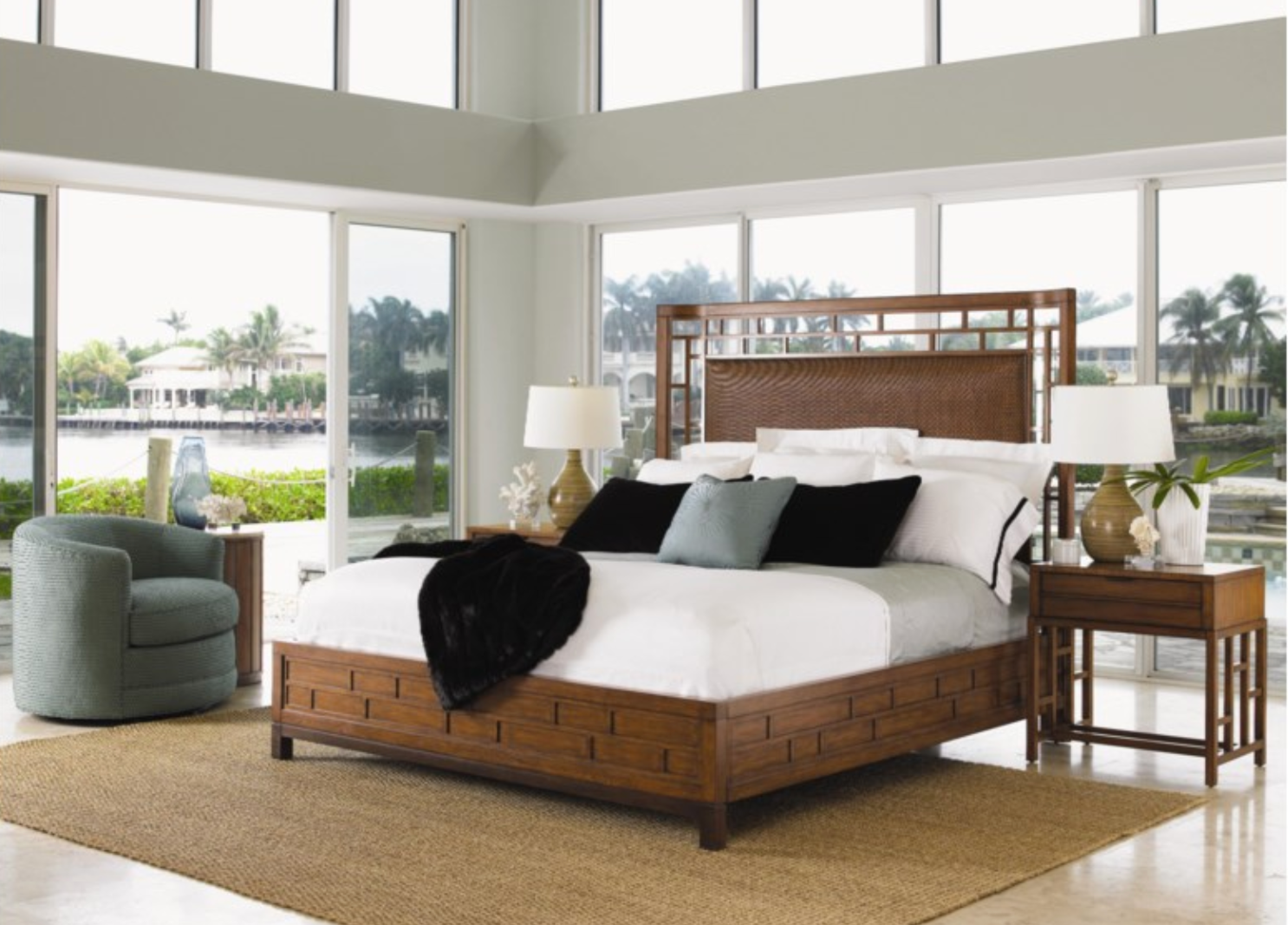 Beautiful room with floor-to-ceiling windows and a king-size rattan bed in the center. 