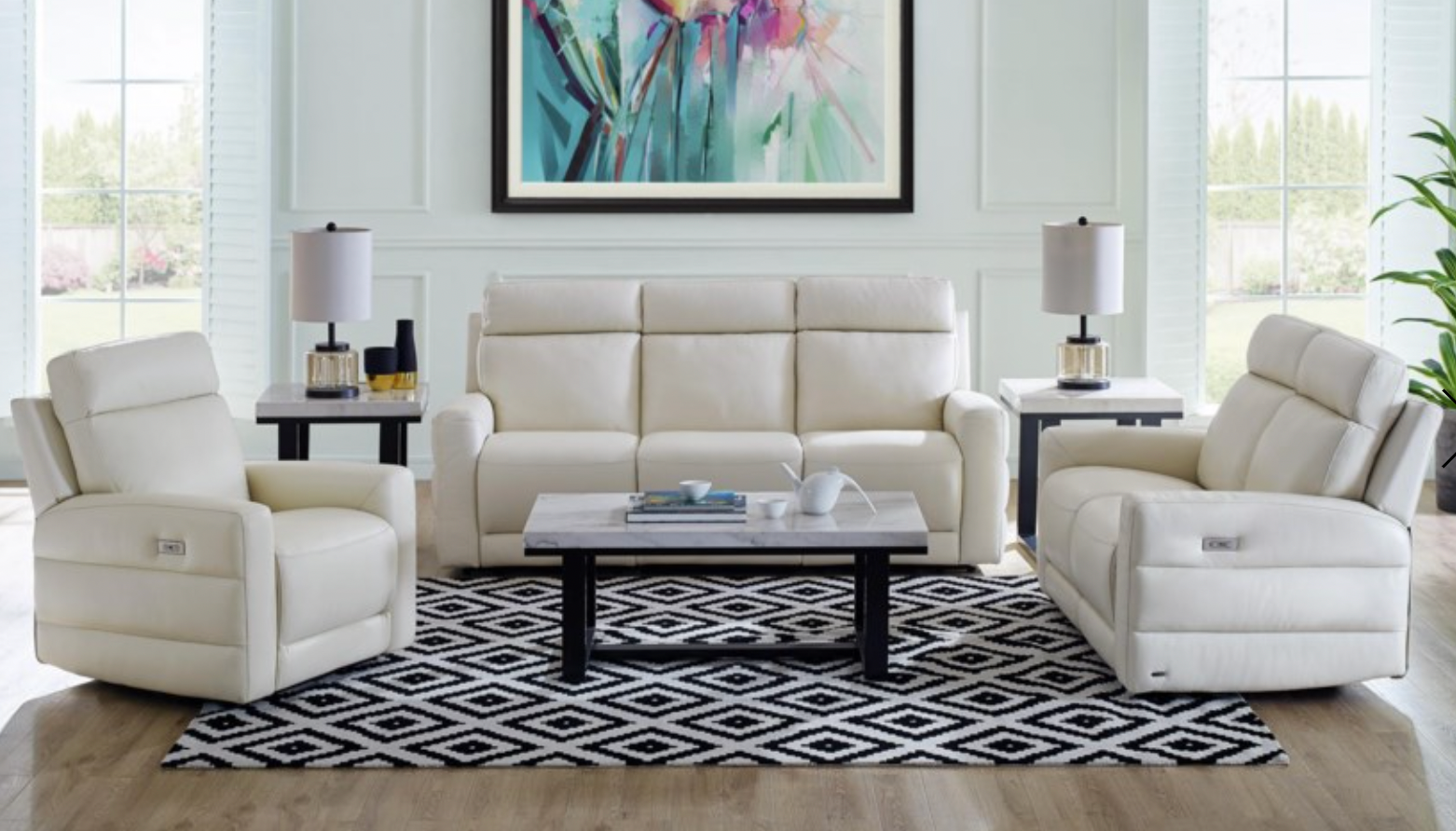 Full living room featuring white leather recliners. 