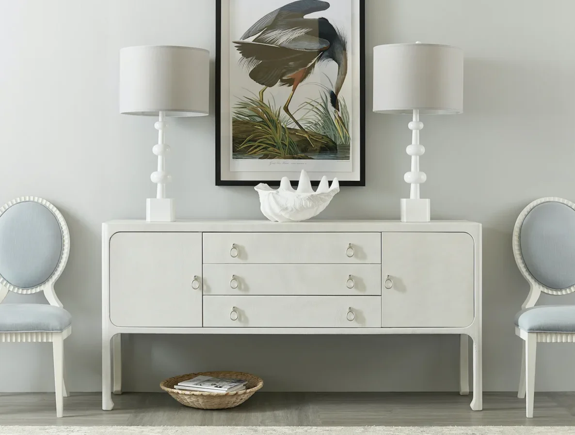 White cabinet with drawers and stilted legs. 