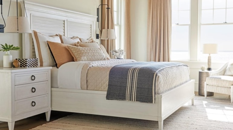 A white louvered bed in a bedroom setting. 