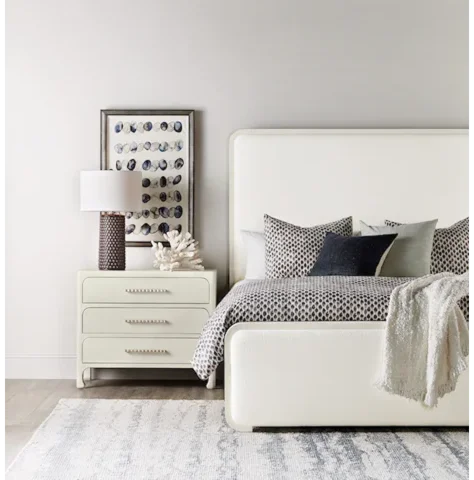 White-colored panel bed in a bedroom setting. 