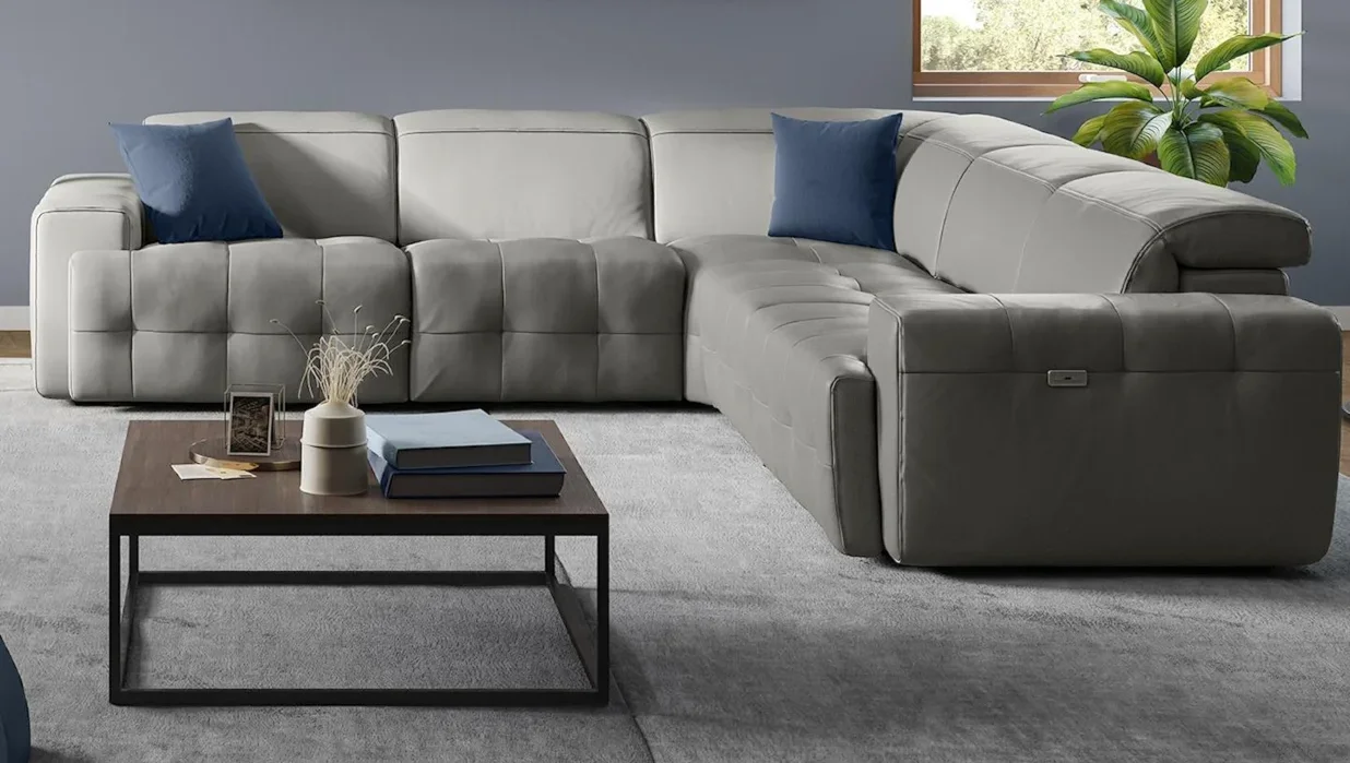 Beautiful, gray leather sectional in living room setting. 