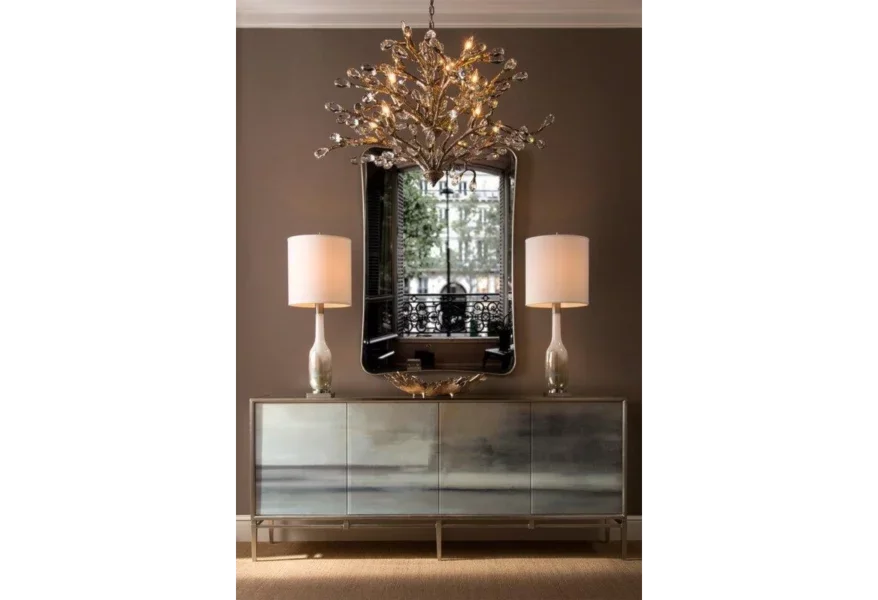Four-door metallic credenza with two lamps on it. 